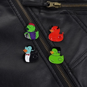 Detail of Halloween horror enamel pins featuring duck monsters on a black leather jacket