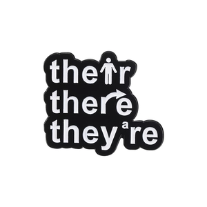 Funny grammar enamel pin featuring Their There They're text on white background