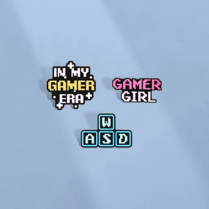 Three-piece retro pixel art enamel pin set with gamer slogans and WASD keys