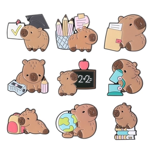 Set of 9 cute capybara enamel pins featuring school and education themes on white background