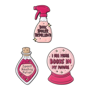 Three-piece set of pink enamel pins featuring book lover potions and crystal ball