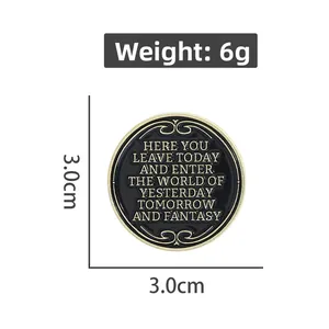 Detailed view of 3.0cm round black and gold enamel pin with fantasy world inscription