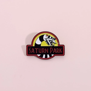 Creative Beetlejuice sandworm and Jurassic Park parody enamel pin on purple background