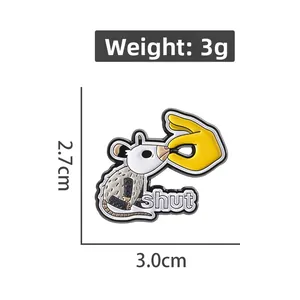 Detail view of cartoon opossum enamel pin with shut text measuring 3.0cm by 2.7cm