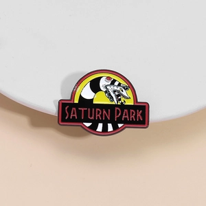Saturn Park enamel pin with black white striped snake and red logo on white plate