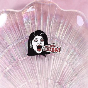 Enamel brooch featuring Soraya Montenegro with Maldita Lisiada text on pearl shell tray