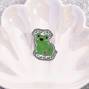 Cute green frog enamel pin with Sana sana Culito de Rana slogan on shell tray