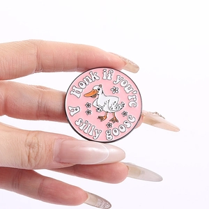 Pink enamel pin featuring a white cartoon goose and Honk if you are a silly goose text