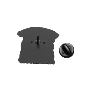 Detailed back view of a black enamel pin with a sharp needle and secure rubber clutch