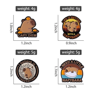 Detail view of cartoon capybara enamel pins with exact dimensions and weight in grams