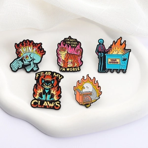 Detailed macro view of five colorful enamel pins with animal and skull designs on a tray