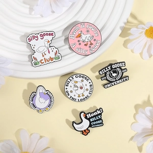 Set of six colorful Silly Goose enamel pins on a white wave tray and daisy background