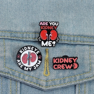 Funny cartoon kidney enamel pin set for nurses featuring medical humor on denim jacket