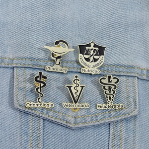 Detail of five medical enamel pins on denim, including Pharmacy and Dentistry designs