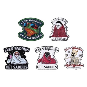 Cartoon enamel pins set featuring frog and skull designs with Even Baddies Get Saddies text