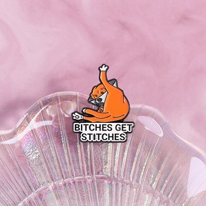 Funny orange cat enamel pin with Elizabeth collar and Bitches Get Stitches slogan