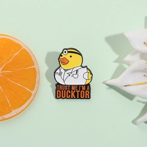 Spilla smaltata papera dottore con testo 'Trust Me I'm a Ducktor' su sfondo verde
