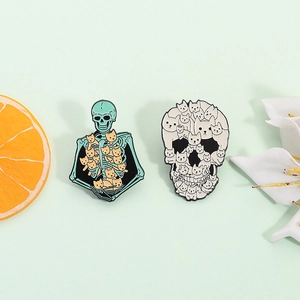 Cute enamel skeleton cat pins featuring orange cat heap and mint green bone frame
