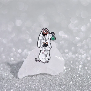 Cartoon scientist mouse enamel pin with lab coat and green flask on glittery background