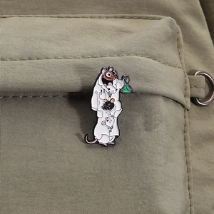 Cute cartoon lab rat enamel pin showing white rats in lab coat on a khaki backpack