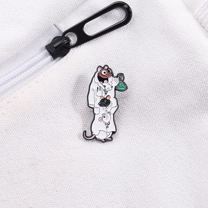 Detail of lab rats enamel pin on canvas fabric showing cute cartoon mice in lab coats