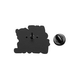 Detailed back view of skull enamel pin with black rubber clutch and textured metal surface