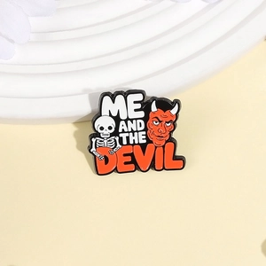 Punk style skull and red devil enamel pin with ME AND THE DEVIL text engraving