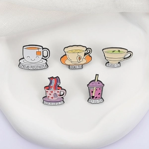 Set of 5 enamel tea and coffee cup pins with motivational slogans on white display
