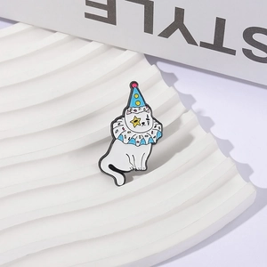 Cartoon white cat clown enamel pin badge with blue hat and yellow star on a white stand