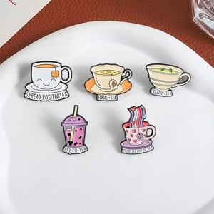 5-piece set of cartoon enamel pins featuring tea and coffee designs on a heart ceramic tray