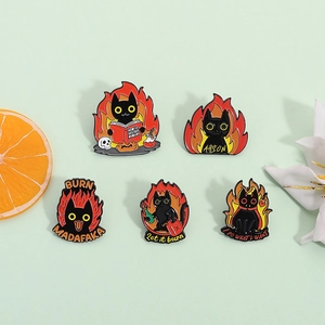 Set of five cute enamel pins featuring black cats with fire designs on green background