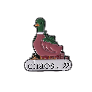 Creative enamel duck pin with burning city design and text chaos on white background