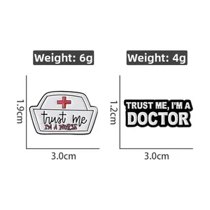 Detail view of medical enamel pins showing nurse hat and doctor text with dimensions