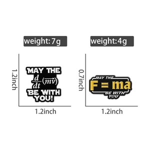 Detail view of science enamel pins showing physics formulas with weight and size specs