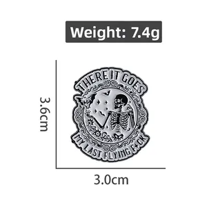 Detail view of a punk enamel pin featuring a skeleton and bat with witty text, 3.6cm size