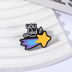 Detail of metal enamel brooch with you did it text and cute smiling star design