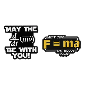 Enamel pins with physics formulas F=ma and d/dt(mv) in yellow and white text on black