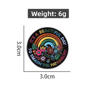 Detail view of 3cm enamel pin with rainbow design and feminist slogan engraving