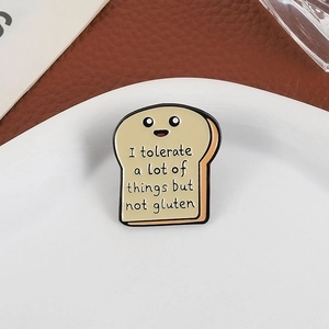 Cartoon bread enamel pin with I tolerate a lot of things but not gluten slogan