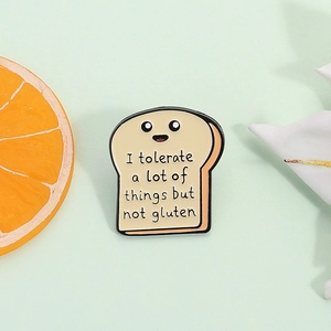 Cartoon toast enamel pin with humor quote on a light green background with orange