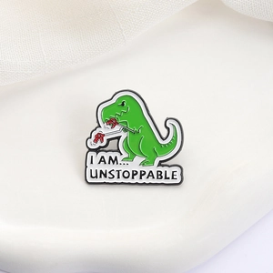 Funny green dinosaur enamel pin with 'I AM UNSTOPPABLE' quote for lapel decoration