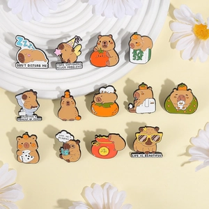 Group shot of 13 cute capybara enamel pins with creative life scene designs in brown and orange