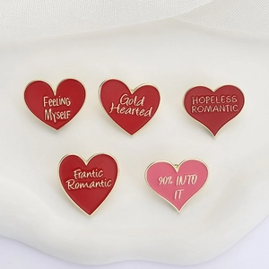 Set di cinque spille in smalto a forma di cuore con bordo dorato e frasi in inglese