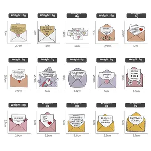 Macro display of 15 enamel envelope pins featuring motivational quotes and colorful designs