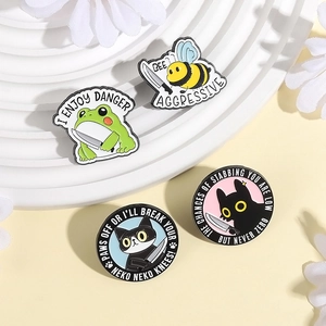 Funny animal enamel pins set featuring aggressive cat, bee, and frog with knives
