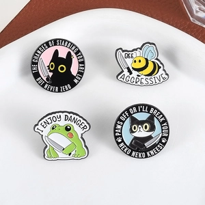 Funny animal enamel pins set with cat, bee and frog holding daggers on ceramic plate