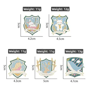 Detail showing five cartoon animal enamel shield pins with rabbit bear and unicorn designs