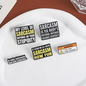 Set of creative sarcastic enamel pins in a ceramic plate on a leather background