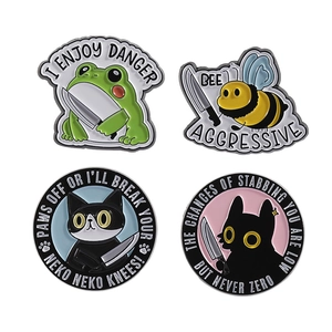 Cartoon animal enamel pins set with frog bee and cat motifs on white background