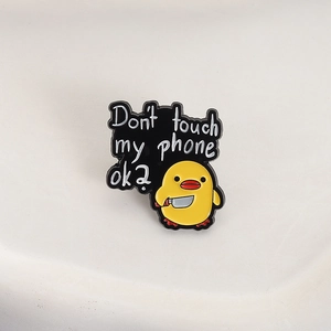 Cute yellow duck enamel pin holding a knife with Don't touch my phone ok text